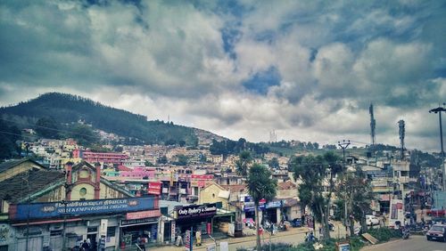 High angle shot of townscape against cloudy sky