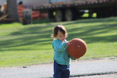 Boy playing with ball in park