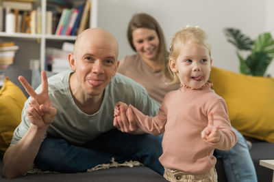 Portrait of happy family sitting at home