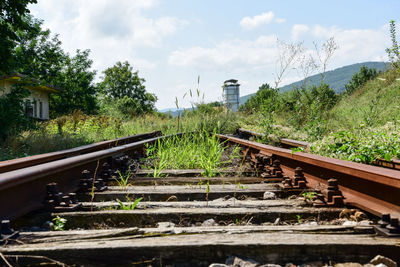 Abandoned railroad tracks against sky