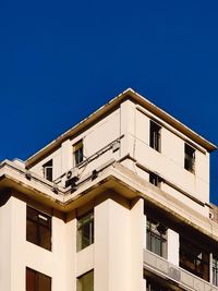 Low angle view of building against clear blue sky