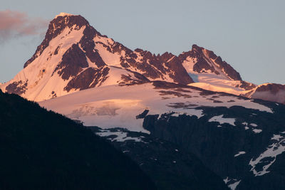 Scenic view of snowcapped mountains against sky during sunset