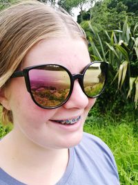 Close-up portrait of happy boy wearing sunglasses