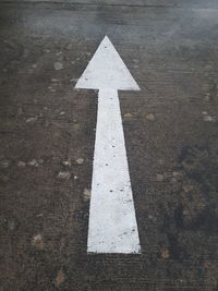 High angle view of arrow sign on road