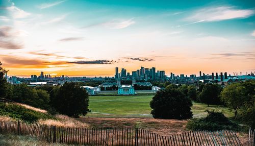 View of buildings in city at sunset