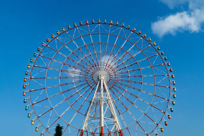 Low angle view of ferris wheel against sky