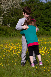 Full length of mother and daughter on field