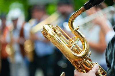 Cropped hand of man holding saxophone