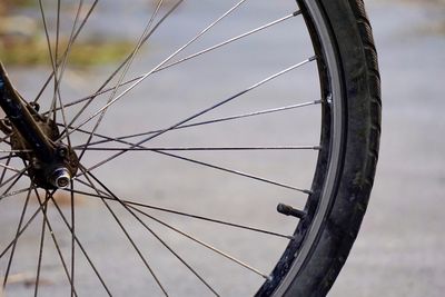 Close-up of bicycle wheel against sky