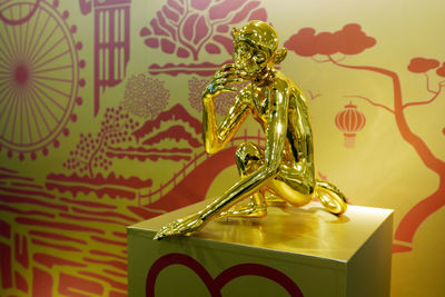 Close-up of gold monkey figurine