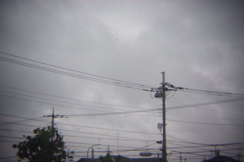 LOW ANGLE VIEW OF POWER LINES AGAINST CLOUDY SKY