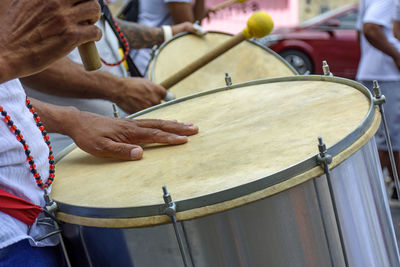 Drummer playing his instrument during carnival celebrations in the streets of brazil