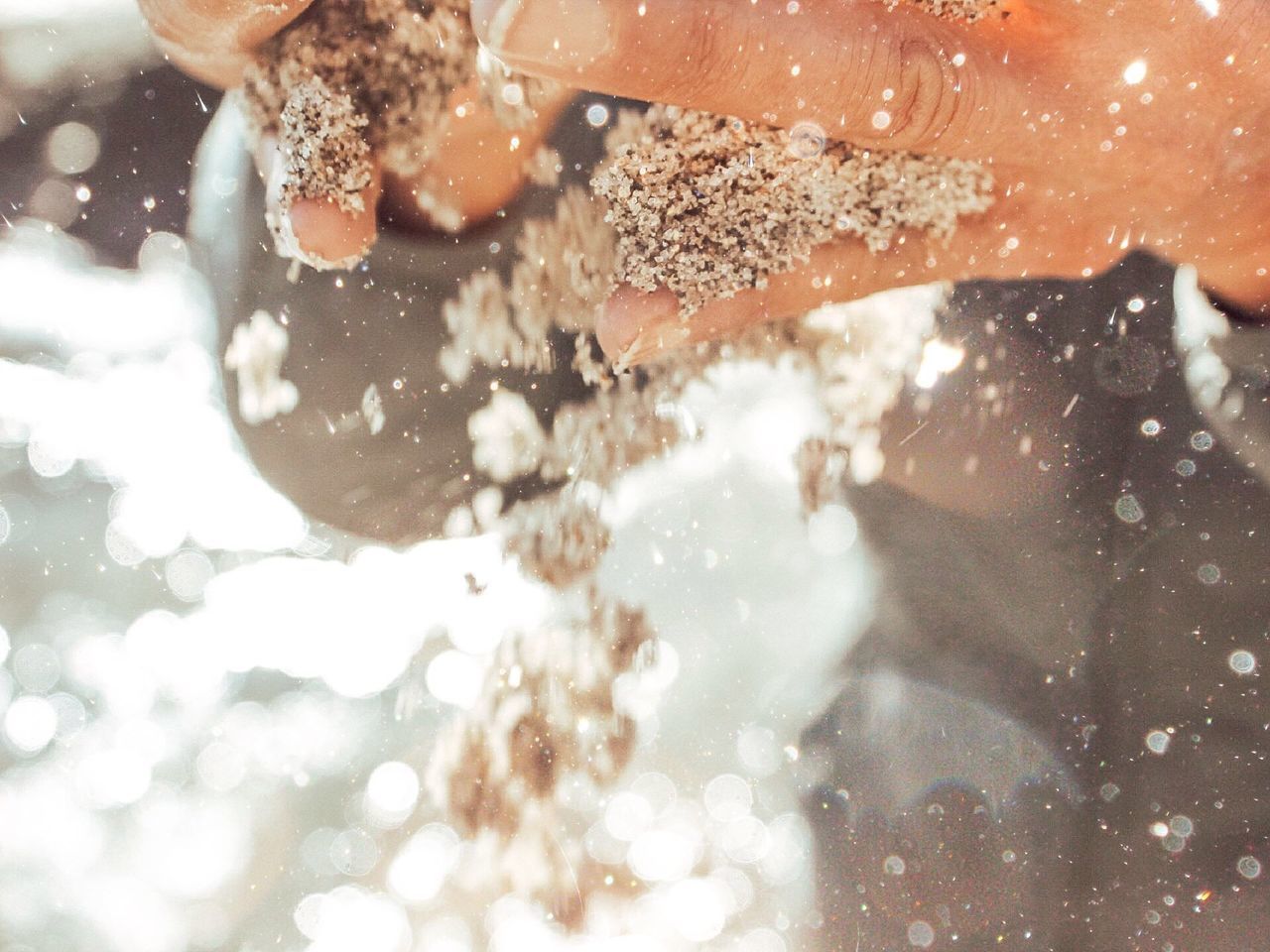 REFLECTION OF PERSON IN WATER SPLASHING ON ROCK