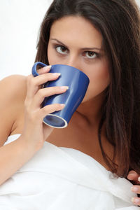 Portrait of a young woman drinking coffee