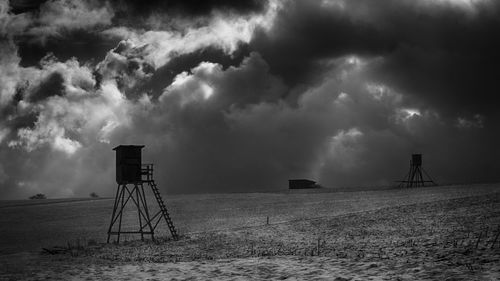 Scenic view of field against storm clouds