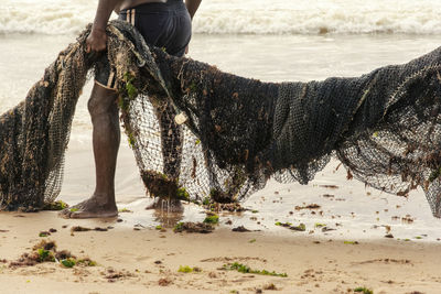 Fishermen pulling their fishing net out of the sea.
