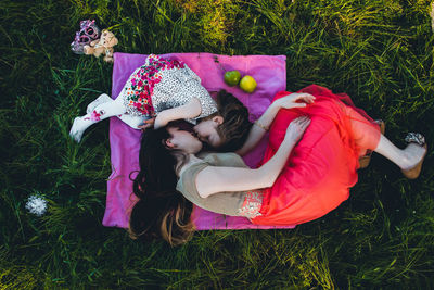 Portrait of mother and daughter on grassy field