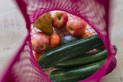 Eco friendly and reusable shopping mesh bag with fruits and vegetables