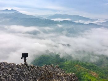 Scenic view of mountains against cloudy sky