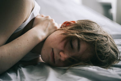 Young woman resting on bed