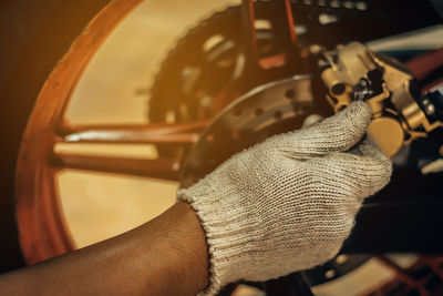 Cropped hands of man working on car