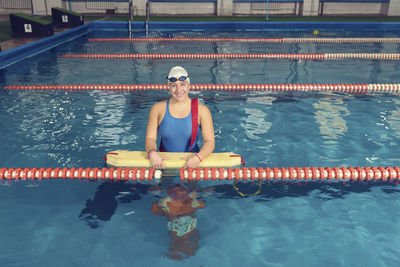 Portrait of woman swimming in pool