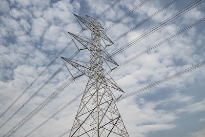 Low angle view of electricity pylon against sky