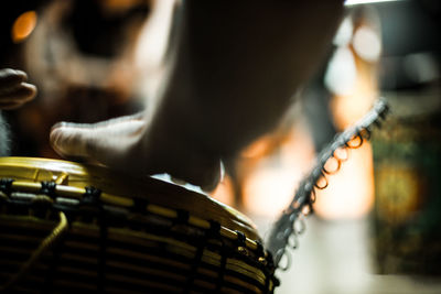 Close-up of hand playing piano