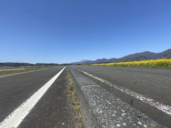 Empty road against clear sky
