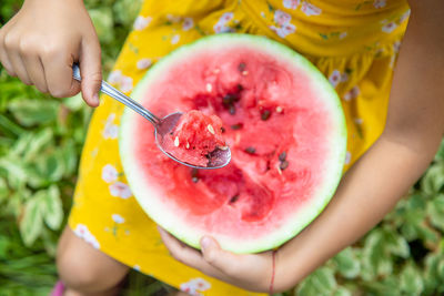 Cropped hand of woman holding food