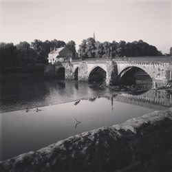 Bridge over river against clear sky