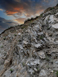 Low angle view of rock formation against sky during sunset