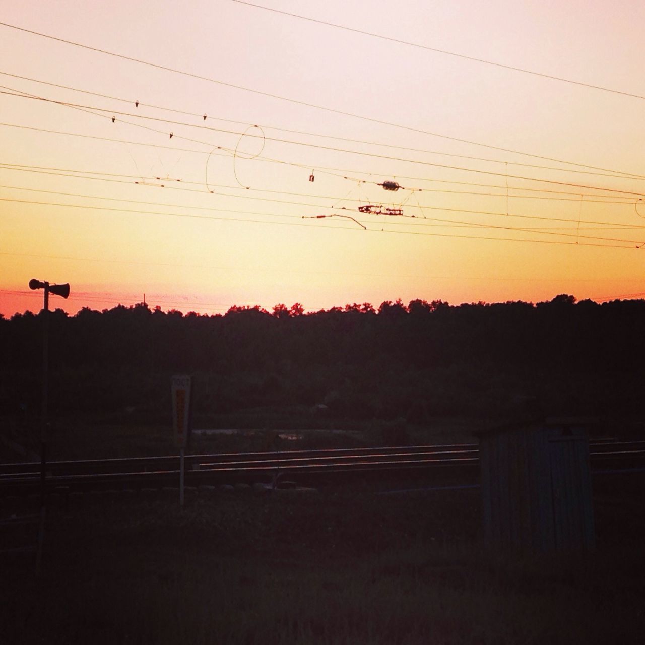 sunset, silhouette, power line, orange color, landscape, tranquil scene, tranquility, scenics, electricity pylon, beauty in nature, nature, sky, fence, tree, clear sky, copy space, connection, electricity, field, dusk