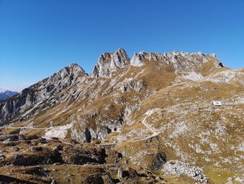 Scenic view of snowcapped mountains against clear blue sky