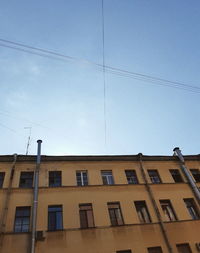 Low angle view of residential building against clear blue sky