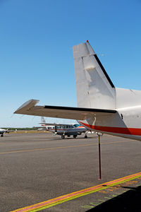 Airplane on airport runway against clear blue sky