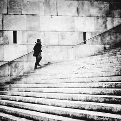 Full length of woman standing on railing