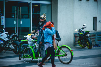 Man riding bicycle on street in city