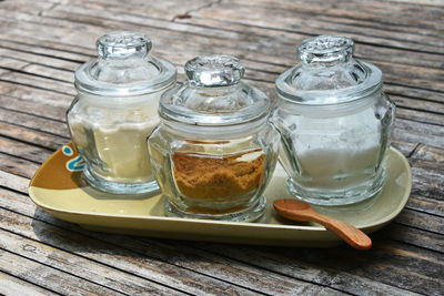 Close-up of food in glass containers on wooden table