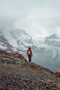 Woman with backpack on mountain background. top of gornergrat, zermatt, swiss. hiking in alps