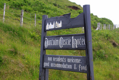 Close-up of sign board on field