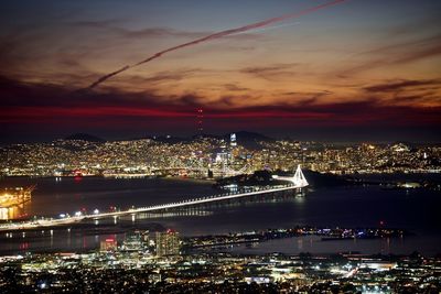 Illuminated cityscape against sky at night