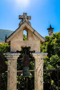 Cross against sky at cemetery