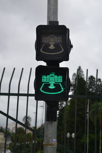 Low angle view of road sign against sky