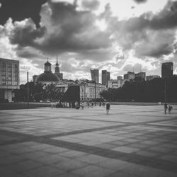 View of city buildings against cloudy sky