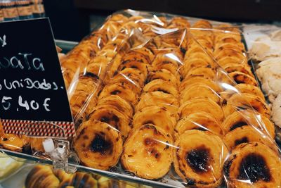 Close-up of sweet food in plastic on display cabinet at store