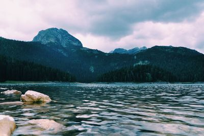 Scenic view of lake and mountains against sky