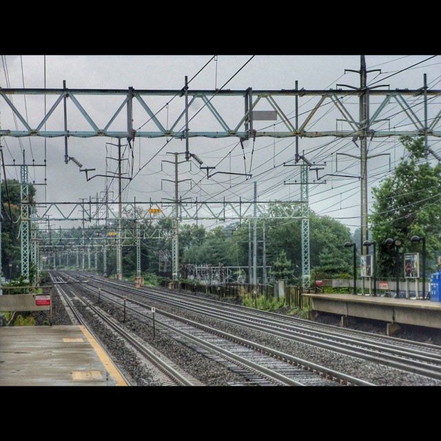 railroad track, transportation, rail transportation, railroad station platform, public transportation, railroad station, train - vehicle, built structure, architecture, sky, train, travel, indoors, mode of transport, railway track, passenger train, city, glass - material, public transport, transparent