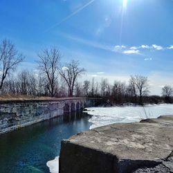 Scenic view of river against sky during winter