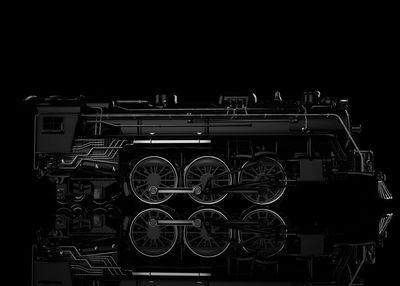 Close-up of machine part against black background